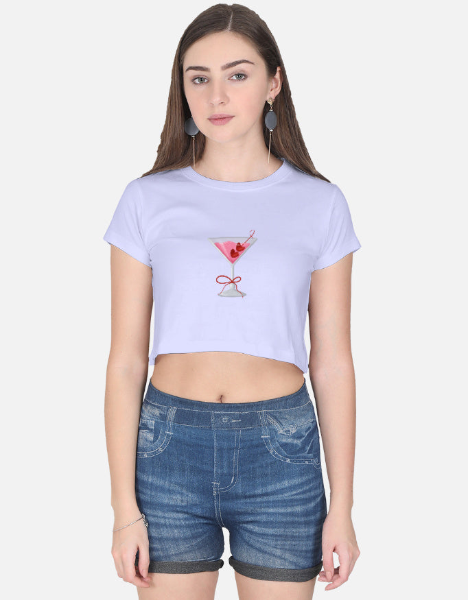 Model wearing purple cotton crop top with pink cocktail embroidery – short sleeves, paired with denim shorts