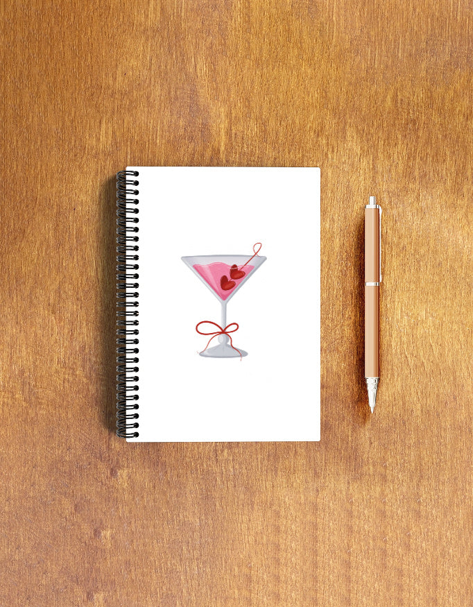 Wire-bound A5 notepad with pink cocktail glass cover – laid flat on wooden surface, ideal for notes, lists, and journaling